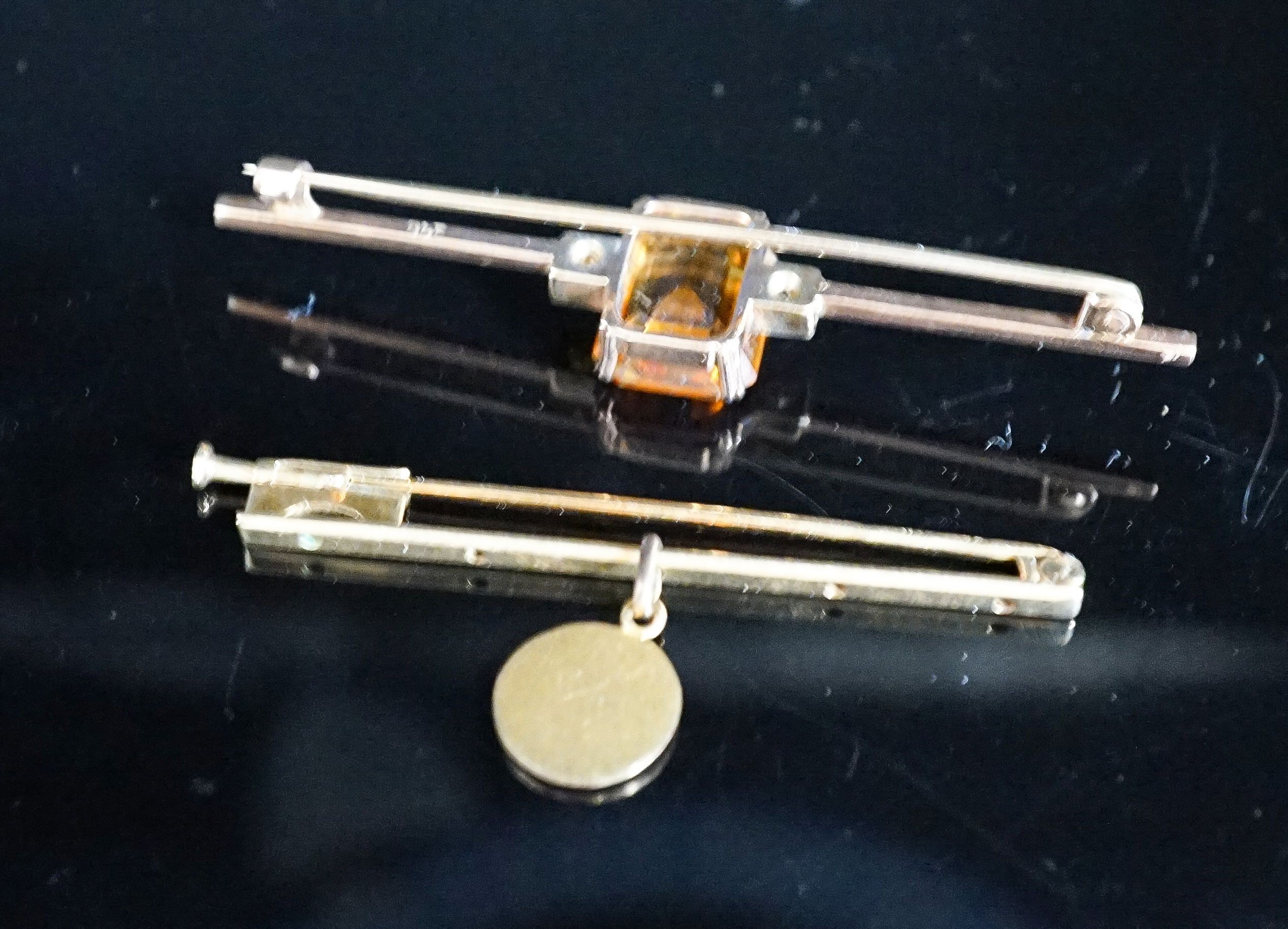 A yellow metal, single stone citrine and two stone diamond set bar brooch, 56mm and one other with cherub pendant charm, gross 6.3 grams.